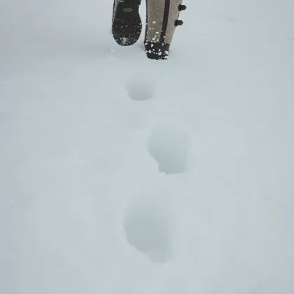 Deep footprints in powder snow at Wetterstein – snow-covered boots breaking trail through winter silence around eriro resort